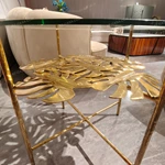 Sculptural Round Glass Sofa Side Table with Gold-Finished Leaf Detail and Textured Metal Frame